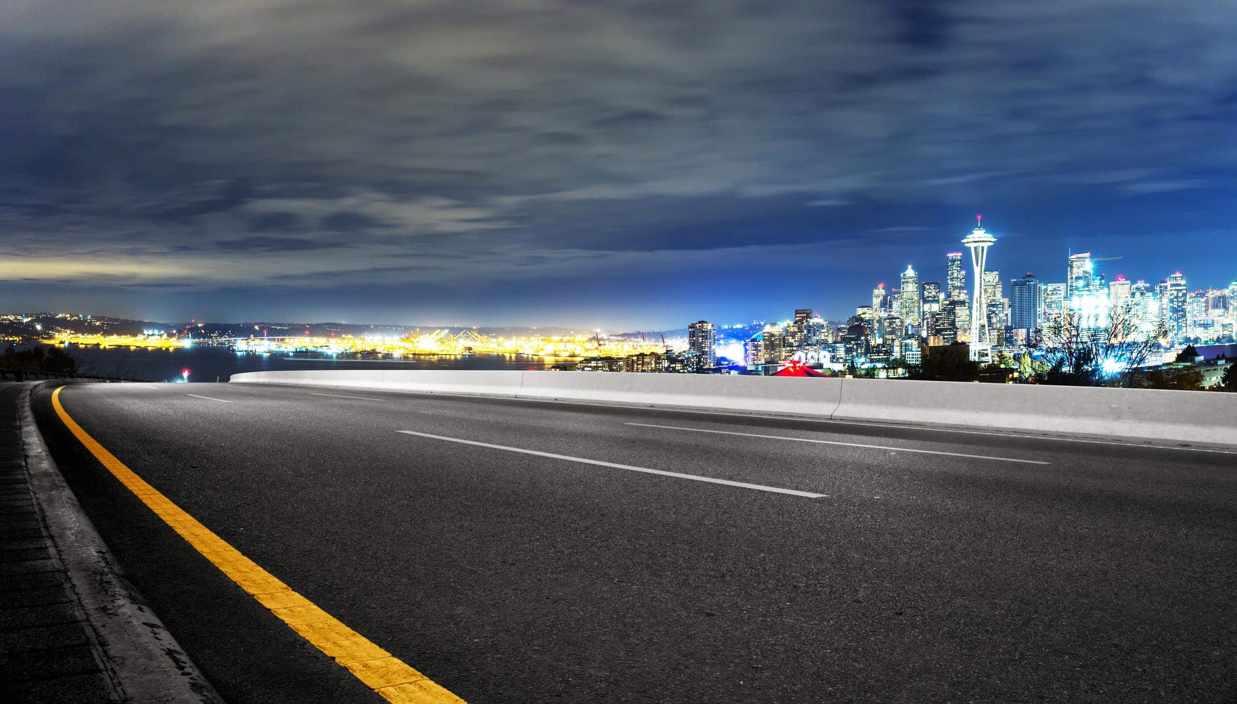 asphalt road with cityscape of seattle at night